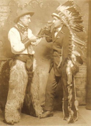Lyle Bullock, the 'cowboy', holds a friend, dressed as an 'Indian', at gunpoint.