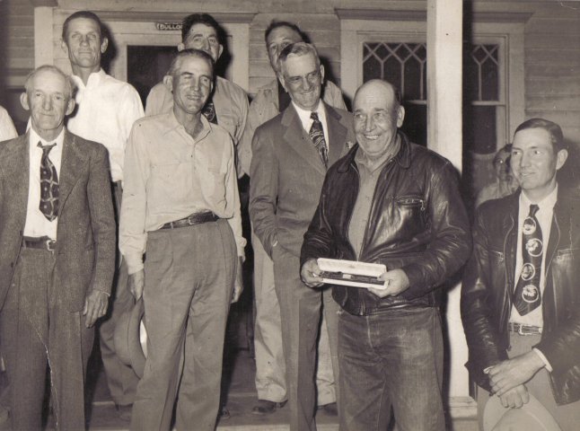 Lyle Bullock is presented with a watch on his retirement from the Postal Service.

Photo taken on the steps of Lyle Bullock's home in Sun City, Kansas.

Photo by Homer Venters,  courtesy of Kim Fowles.