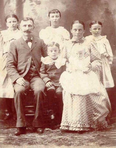 Bonnie Pearl (Adams) Wells as a young woman with her parents & siblings.

Back row:  Bonnie Pearl (Adams) Wells, Bessie (Adams) Kidd, Beaulah Adams.
 
Samuel Jefferson Adams & his wife Cora Edith (Painter) Adams are holding two of their 2 sons.

Photo courtesy of Kim Fowles.