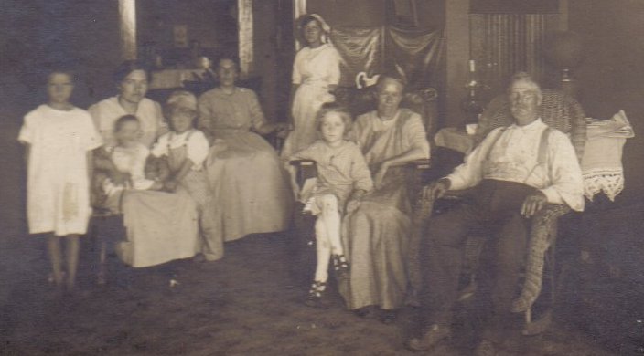 Photo of interior of Owens General Store in Belvidere. Rev. Charles W. Owens sitting in rocking chair, Mollie Owens sitting next to him. Other people in photo unidentified. Belvidere, Kiowa County, Kansas.

Photo courtesy of Kim Fowles.