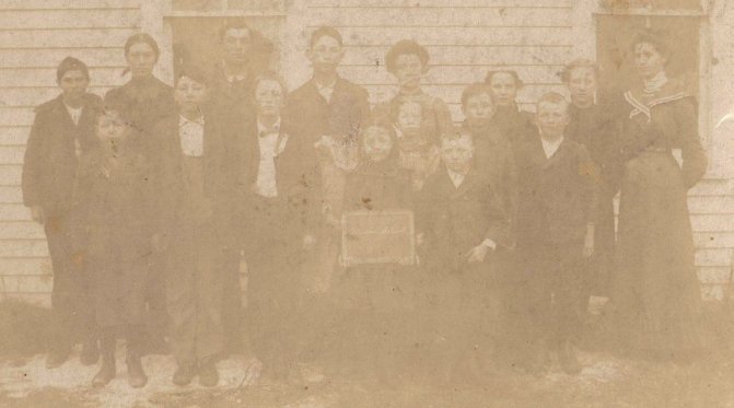 Oliver Owens, 3rd from left in front row, with his schoolmates, Belvidere, Kiowa County, Kansas, circa 1897.