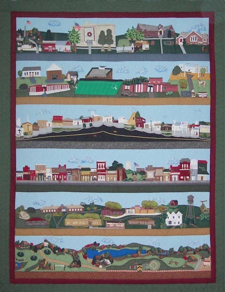 'COME HOME TO COLDWATER - 2003'  QUILT: 

Panel 1: Southeast side of Coldwater, featuring the Court House, Cemetery, Methodist & Presbyterian Churches, Firehouse, etc.
 
Panel 2: Northeast side of Coldwater, featuring the High School, Measurement Inc (old grade school), Football Stadium, & Fairgrounds.
 
Panel 3: Highway showing churches and buildings on both sides.
 
Panel 4: Main Street featuring Heritage Park and businesses on both sides of Main including Banks, Chief Theater, etc.
 
Panel 5: West side of Coldwater, featuring Park, Pioneer Lodge, the Hospital, Medical Clinic, Farm Bureau Office, County Health/Dental Clinic, a rural home west of Coldwater and the Water Tower.
 
Panel 6: South of Coldwater, featuring the Country Club & Golf Course, Coldwater Lake and Campground, the Baseball Diamonds, and a Welcome-to-Coldwater Sign